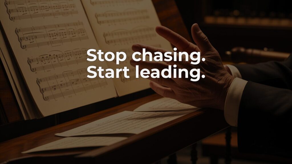 A conductor's hands resting on a music stand—a visual metaphor for pausing amid leadership overwhelm to find clarity