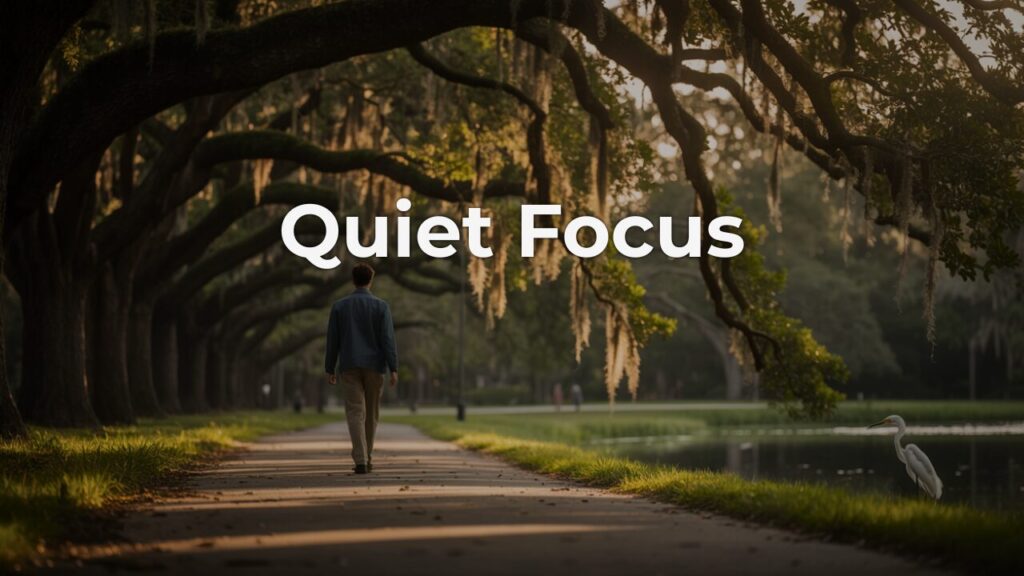 A man walking alone beneath arching live oak trees draped in Spanish moss, an egret standing near a still pond — a morning walk toward quiet focus.