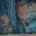 Dramatic layers of sedimentary rock in deep blue, terracotta, and cream reveal the visible record of accumulated time — each stratum a pattern deposited quietly over years.